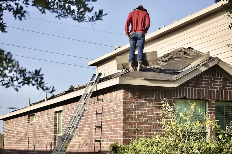 Professional roofer working on a residential roof in Gardenview
